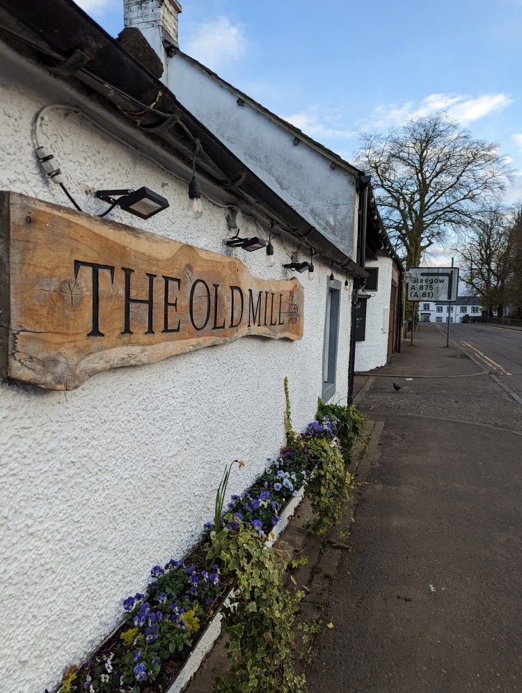 Wooden sign that reads The Old Mill